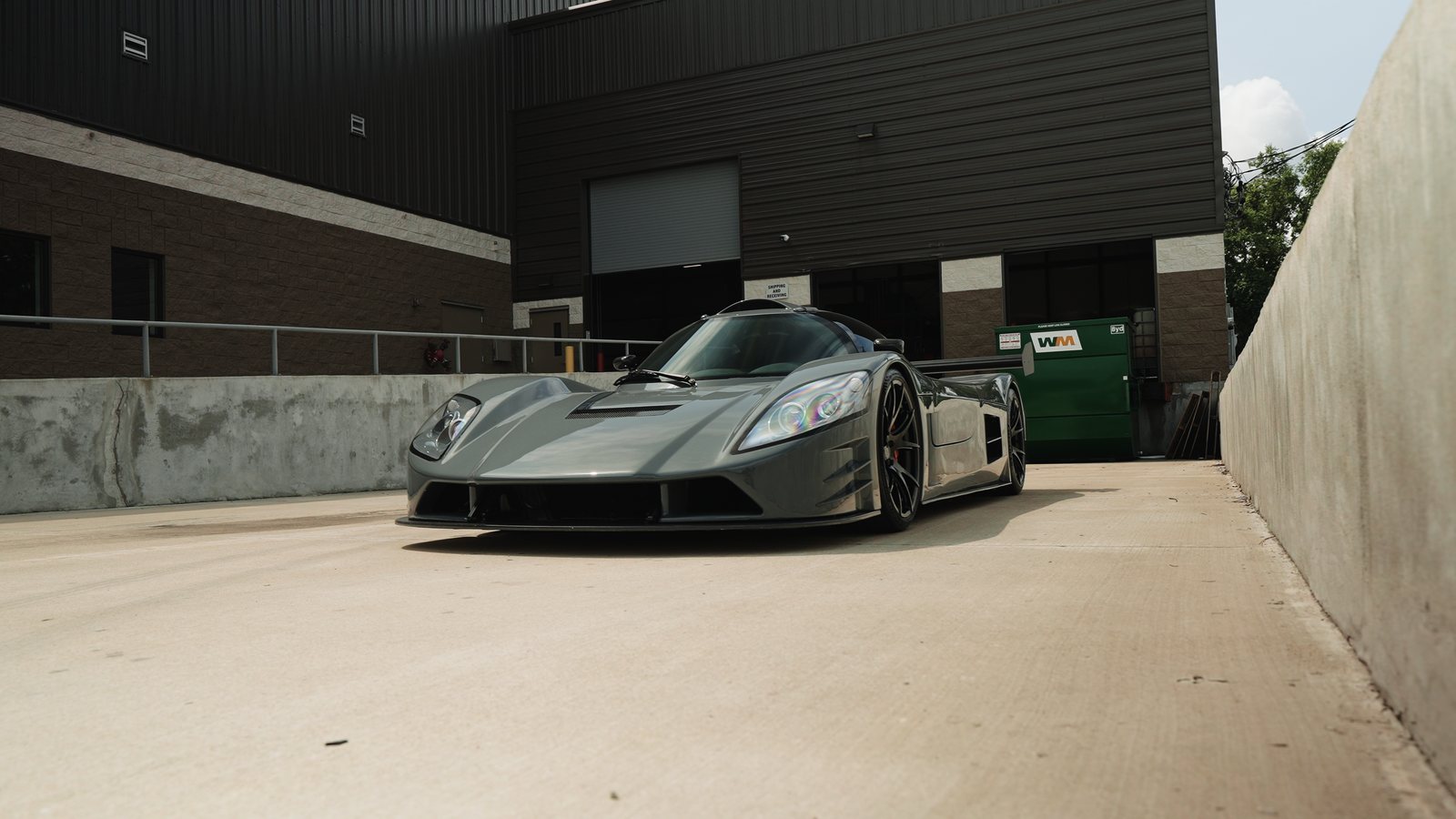 A parked hypercar shot front three-quarter in an alley
